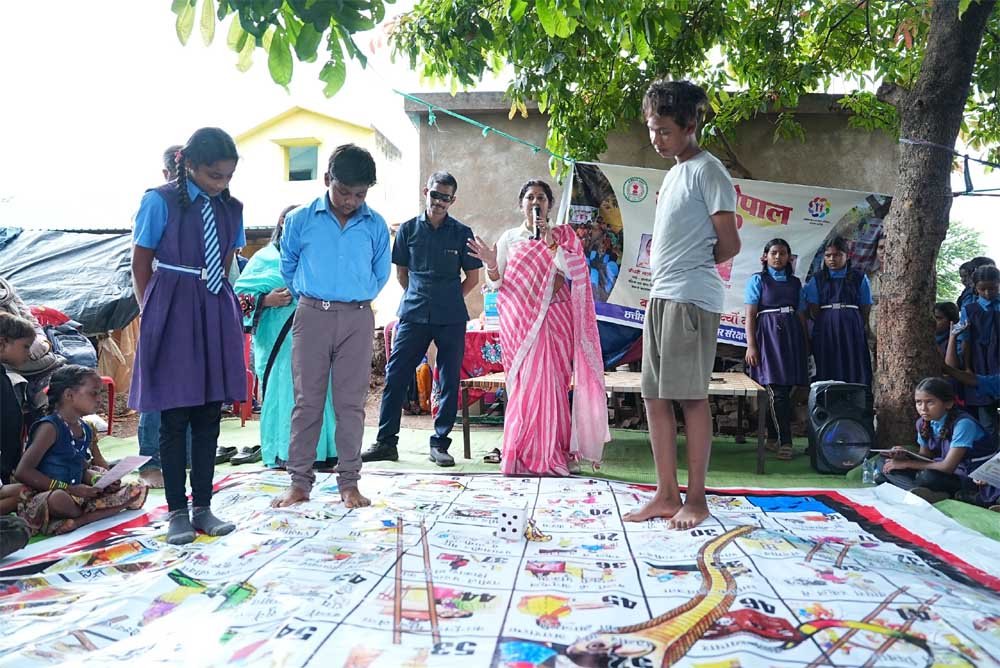 Children from the snake charmer community played 'Snakes and Ladders' based on child rights