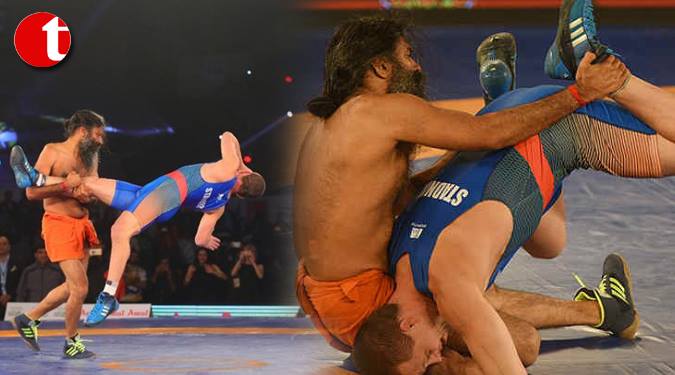 Baba Ramdev wrestles, beats Olympic medallist 12-0
