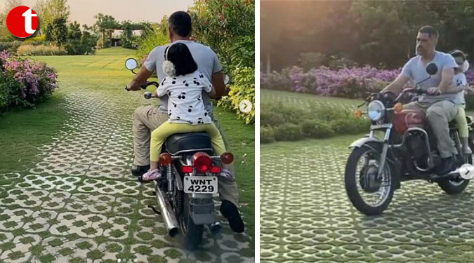 Sakshi captures Dhoni taking Ziva on a bike ride at home