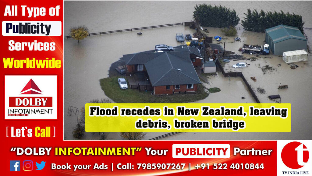 Flood recedes in New Zealand, leaving debris, broken bridge